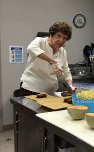 Carolyn Lack cutting brownies